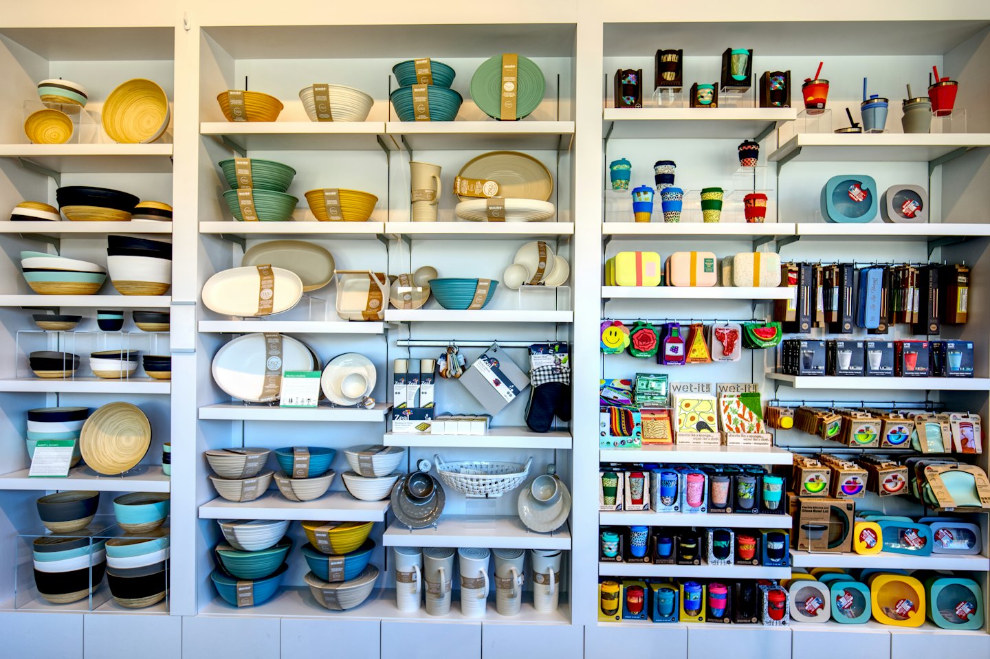 Eco-friendly bamboo kitchenware arranged neatly on store shelves.