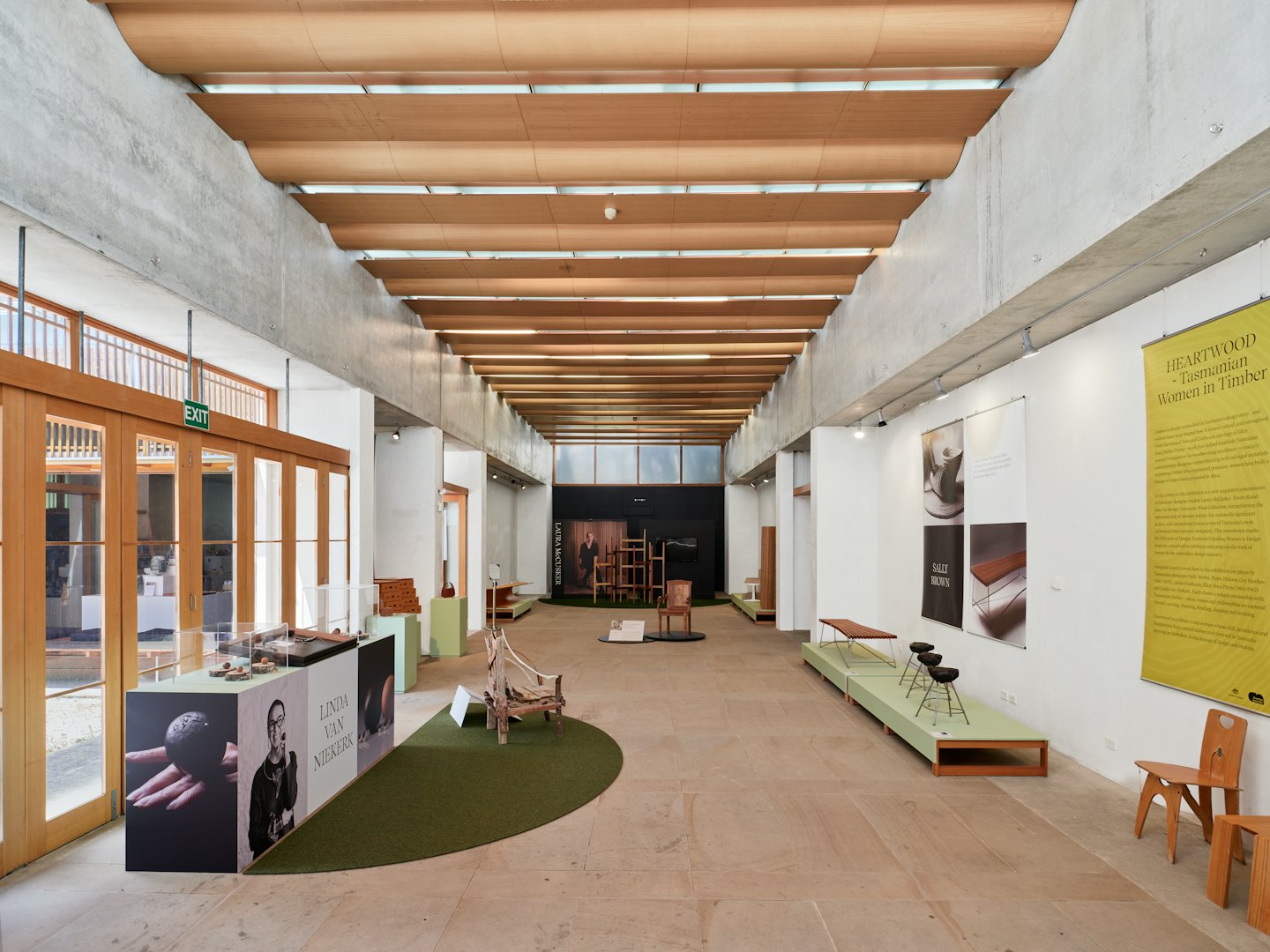 Wooden furniture and crafts displayed in a modern exhibition hall.
