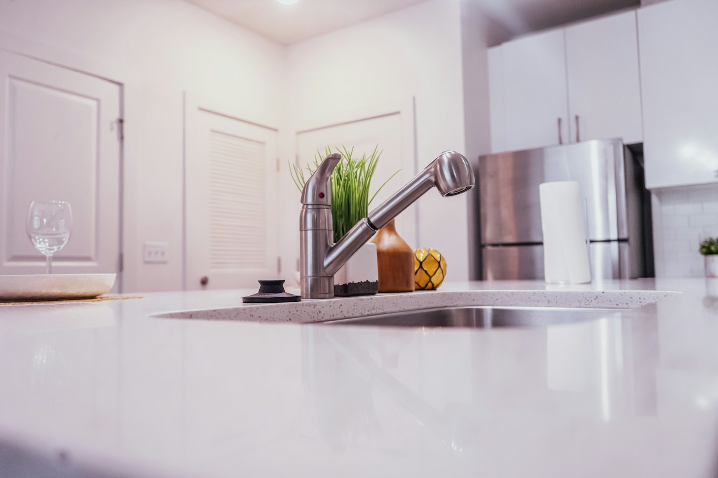 Decorated kitchen countertop with a faucet and potted plant.
